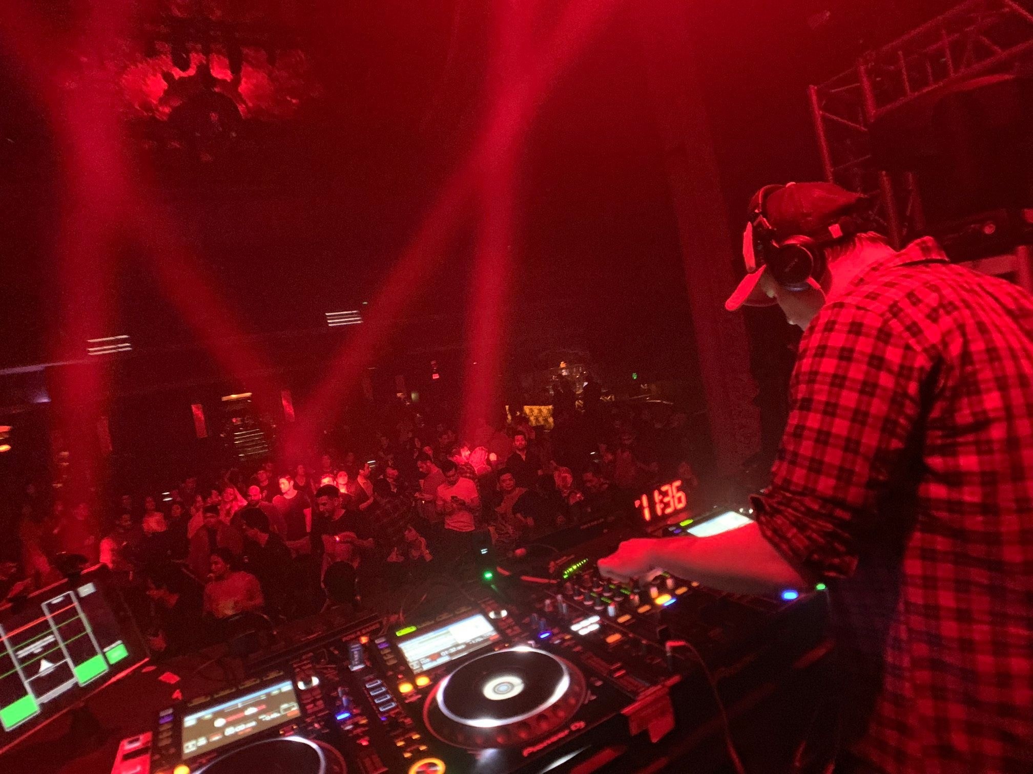 CDJs in a red-lit room